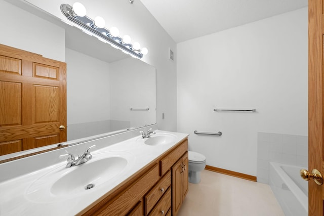 bathroom featuring toilet, vanity, and a tub to relax in