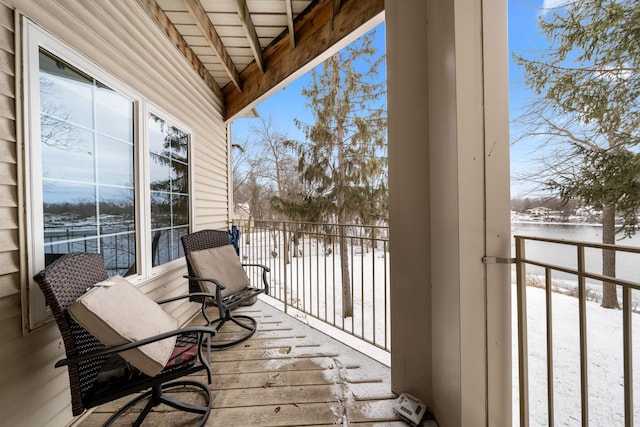 view of snow covered back of property