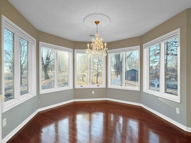 unfurnished sunroom featuring a notable chandelier