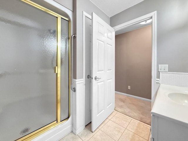 bathroom featuring tile patterned floors, vanity, and walk in shower