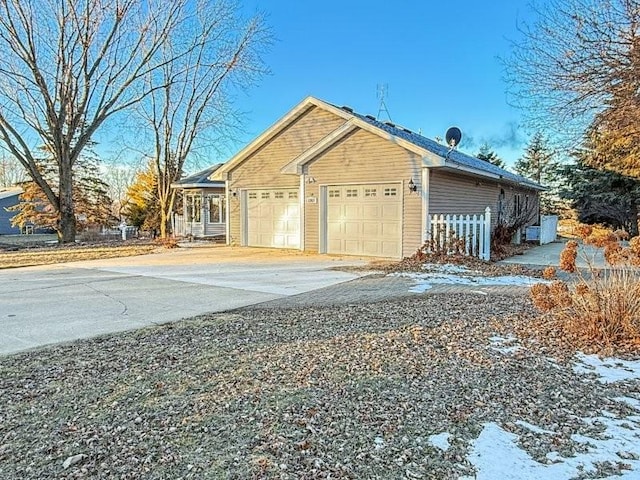 snow covered property featuring a garage