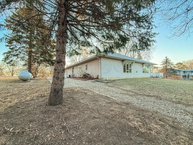 view of side of property with a lawn