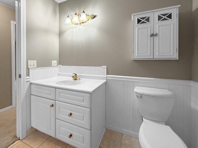 bathroom featuring toilet, vanity, and tile patterned floors