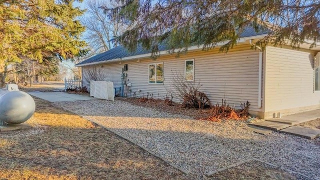 view of property exterior with a patio area