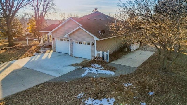 property exterior at dusk featuring a garage