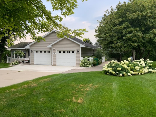 ranch-style house featuring a front lawn and a garage