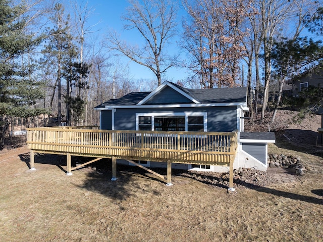 view of front of house featuring a front lawn and a deck