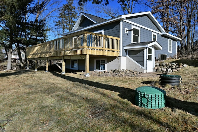 view of side of home with a yard, central AC, and a deck