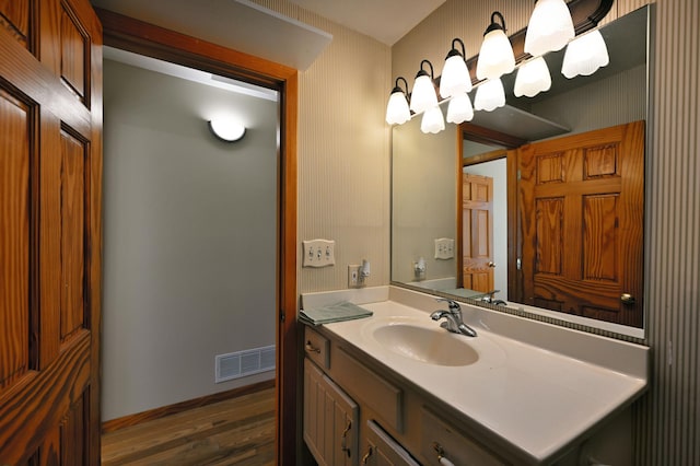 bathroom with hardwood / wood-style floors and vanity