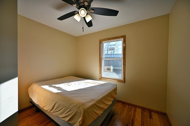 bedroom featuring dark hardwood / wood-style flooring and ceiling fan