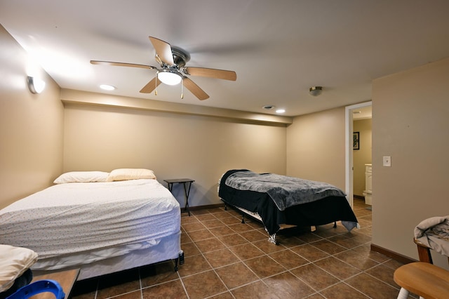 bedroom with dark tile patterned flooring and ceiling fan