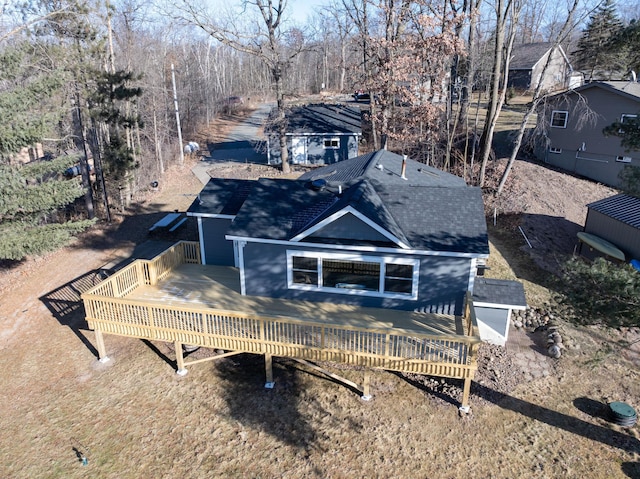 rear view of property featuring a wooden deck