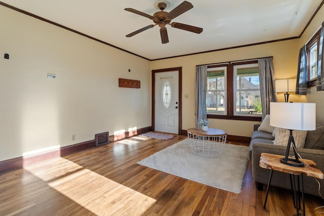 unfurnished living room featuring ceiling fan, hardwood / wood-style floors, and ornamental molding