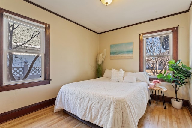 bedroom with light hardwood / wood-style flooring and ornamental molding