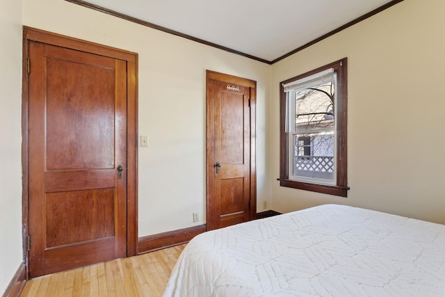 bedroom with light hardwood / wood-style floors and crown molding