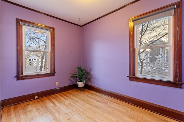 unfurnished room featuring light wood-type flooring and ornamental molding