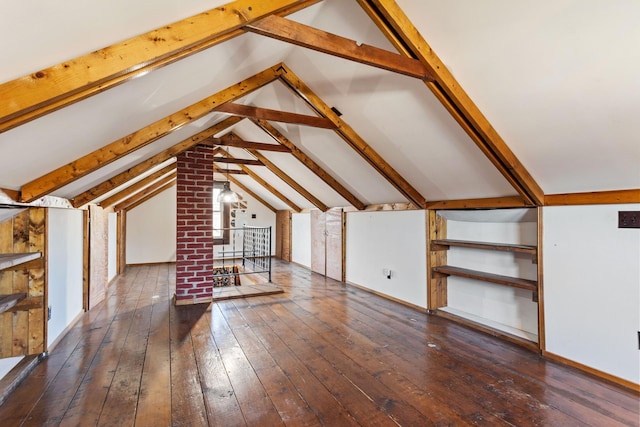 additional living space with dark hardwood / wood-style flooring and lofted ceiling with beams