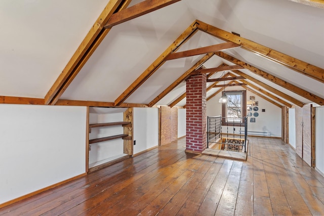 additional living space with vaulted ceiling with beams, a baseboard heating unit, and hardwood / wood-style flooring