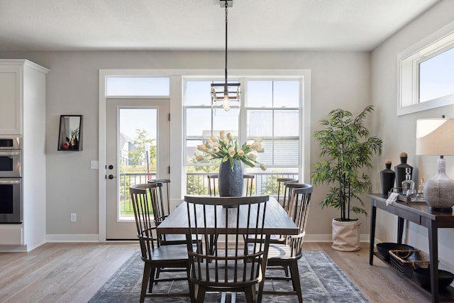 dining area featuring a chandelier and light wood-type flooring