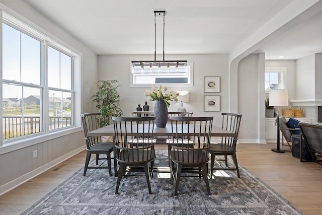 dining space featuring dark hardwood / wood-style floors, plenty of natural light, and a notable chandelier