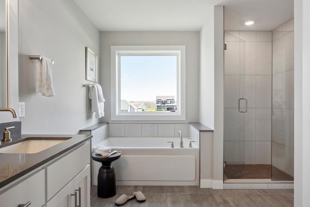 bathroom with plus walk in shower and vanity