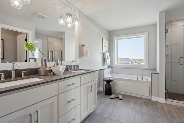 bathroom featuring plus walk in shower and vanity