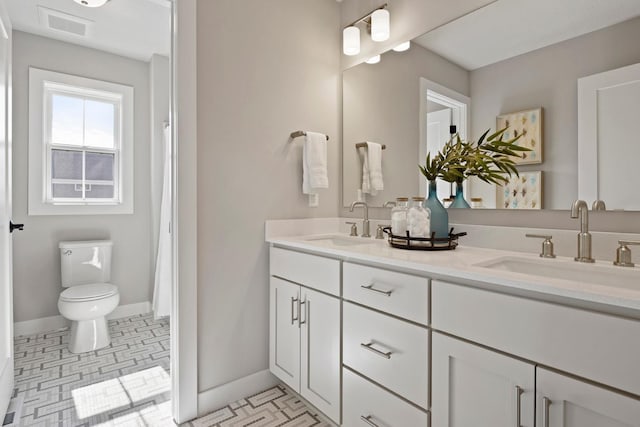 bathroom featuring tile patterned flooring, vanity, and toilet