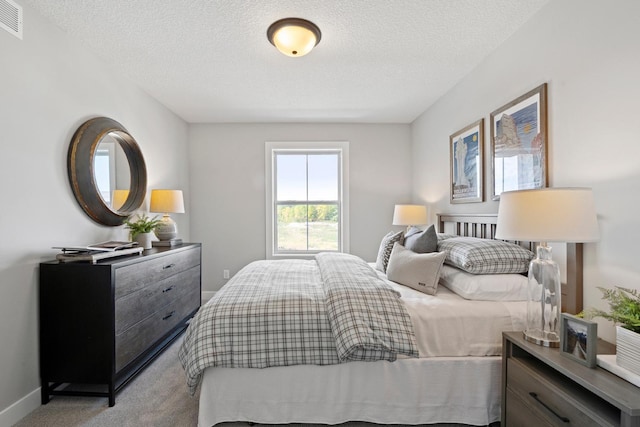 carpeted bedroom featuring a textured ceiling