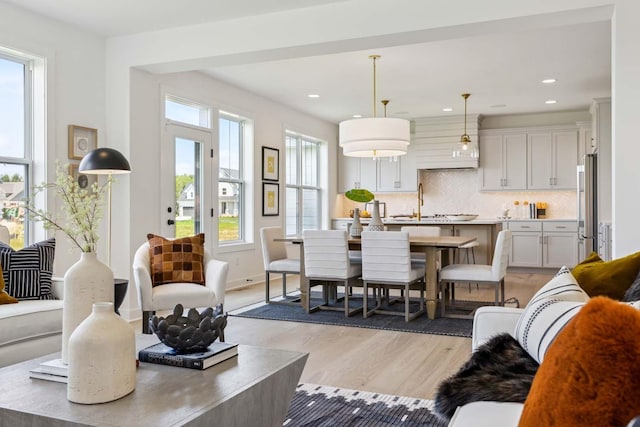 dining area featuring light hardwood / wood-style floors and sink