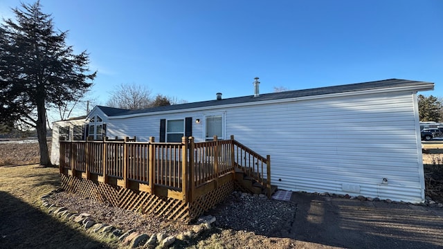 back of house featuring a wooden deck