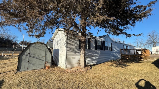 view of home's exterior with a storage shed and a deck