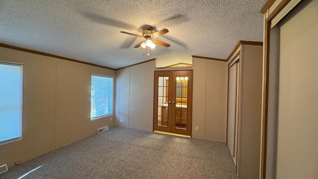 spare room with carpet, french doors, vaulted ceiling, and ceiling fan