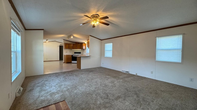 unfurnished living room with vaulted ceiling, light carpet, ceiling fan, and a textured ceiling