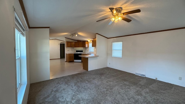 unfurnished living room featuring ceiling fan, light colored carpet, and lofted ceiling