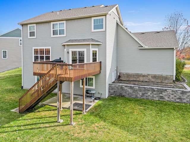 rear view of property with a lawn, a patio area, and a wooden deck