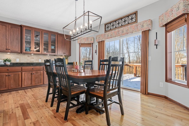 dining room featuring light wood-type flooring and a chandelier