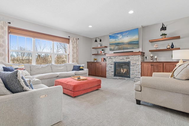 living room featuring a textured ceiling, light colored carpet, and a fireplace