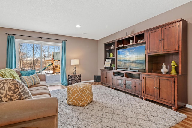 living room featuring a textured ceiling and hardwood / wood-style flooring