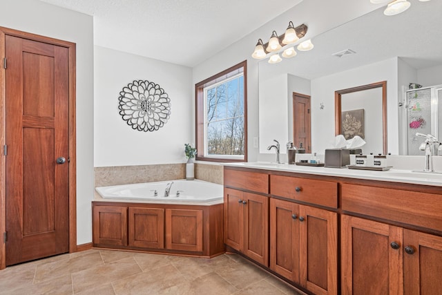 bathroom with vanity, a textured ceiling, and shower with separate bathtub