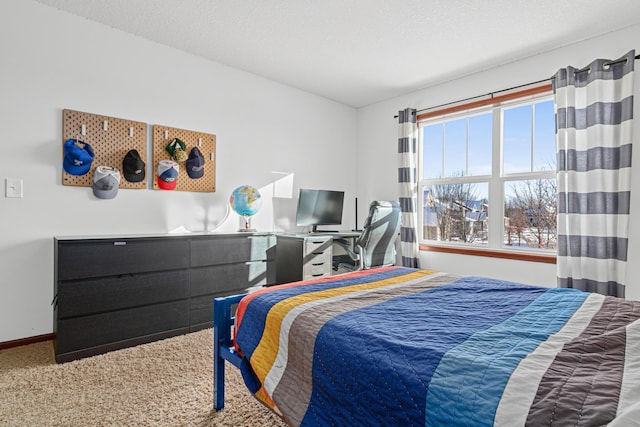 bedroom with a textured ceiling and carpet