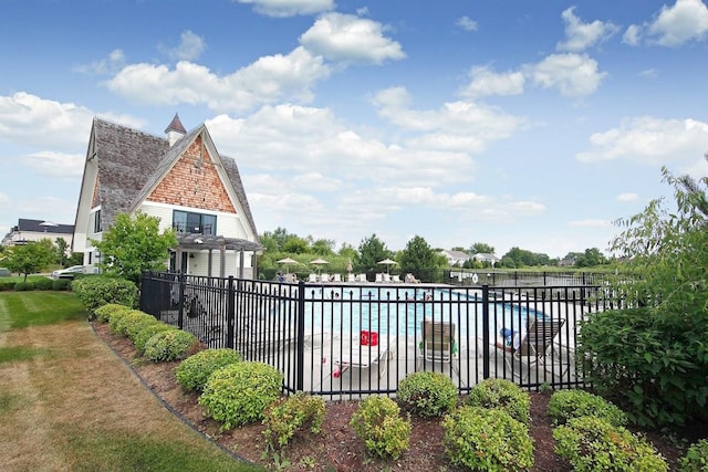 view of swimming pool featuring a water view and a pergola