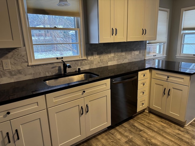 kitchen with decorative backsplash, sink, wood-type flooring, dishwasher, and white cabinetry