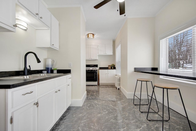 kitchen with white cabinets, sink, ornamental molding, white range oven, and radiator heating unit