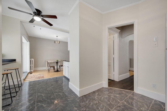 interior space with radiator, ceiling fan, and ornamental molding