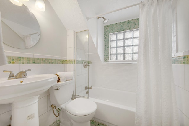 full bathroom with sink, shower / bath combo, tile walls, and toilet