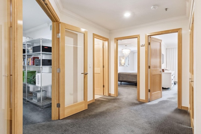 corridor featuring crown molding and dark carpet