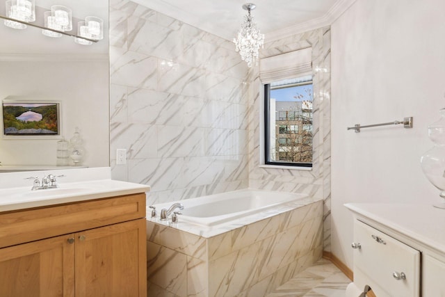 bathroom with ornamental molding, tiled bath, vanity, and an inviting chandelier