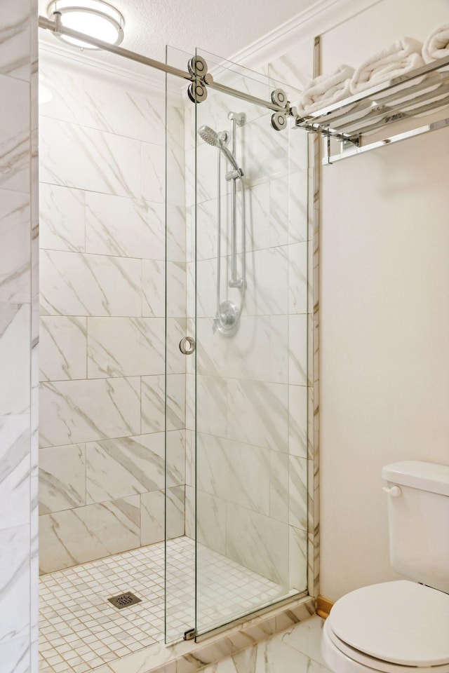 bathroom featuring walk in shower and toilet