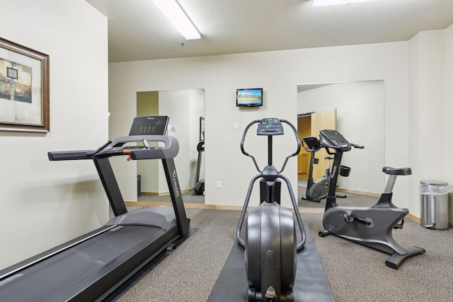 exercise room featuring a textured ceiling