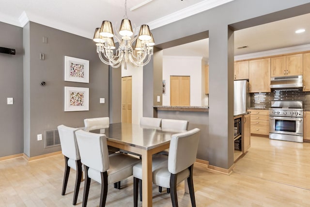 187 Sherman St, Saint Paul, MN 55102 - dining space with a chandelier, baseboards, crown molding, and light wood-style flooring